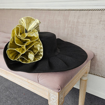 Extra large black gold formal occasion hat for a wedding guest