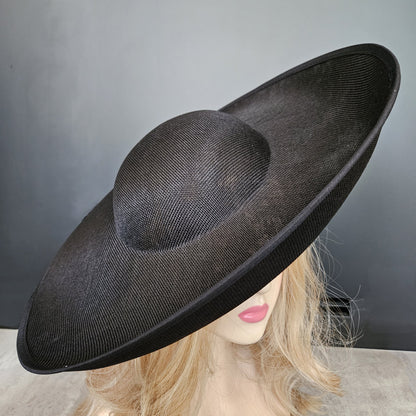 A wide-brimmed big black fascinator hat  - hats for ky derby.
